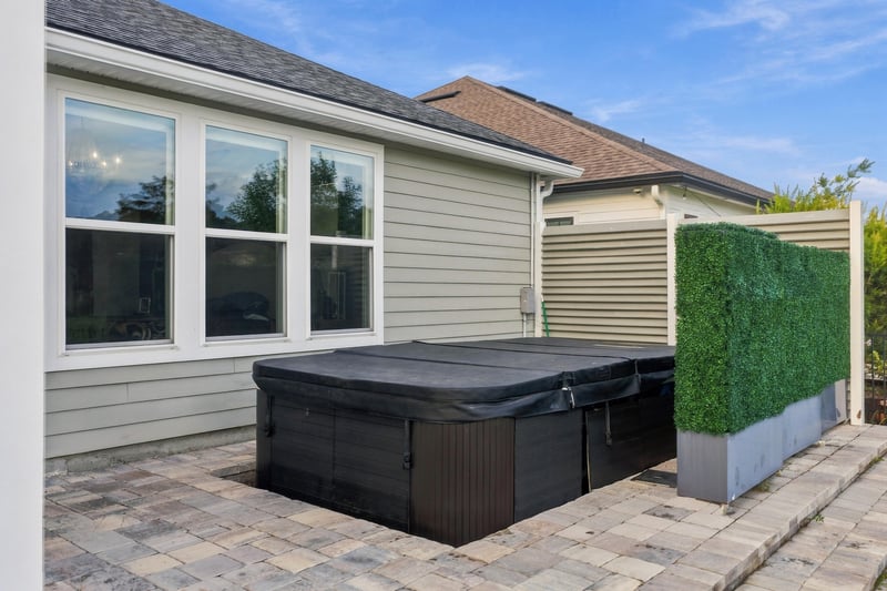 Covered hot tub on the back patio at 3921 Spyglass Hill Ln