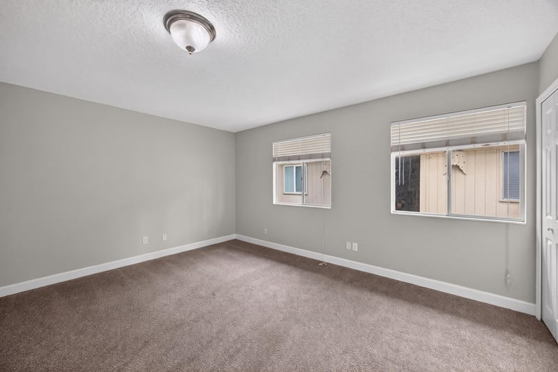 Bedroom with carpet and two windows at 1800 Park Ave apt 358, Orange Park, FL