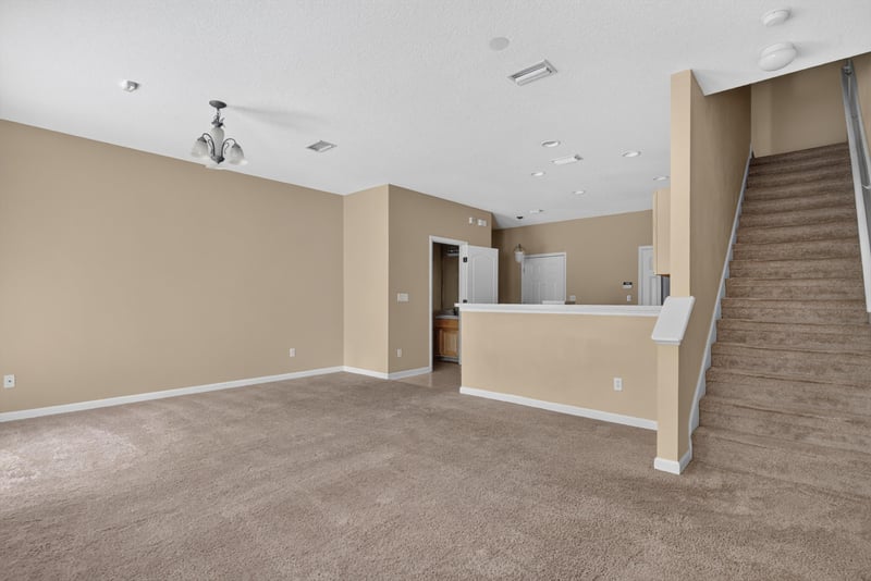 Living room with staircase view at 12359 Mangrove Forest Ct, Jacksonville, FL 32218