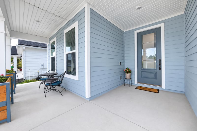 Covered front porch with seating area and entry door at 2354 Jennings Farm Dr, Middleburg, FL 32068