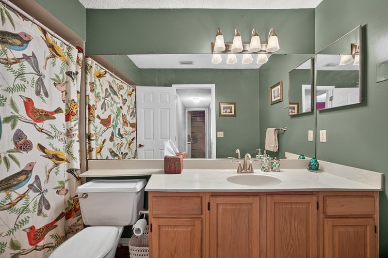 Bathroom with dual vanity and patterned wallpaper at 4837 Pareja Ct, Jacksonville, FL 32225