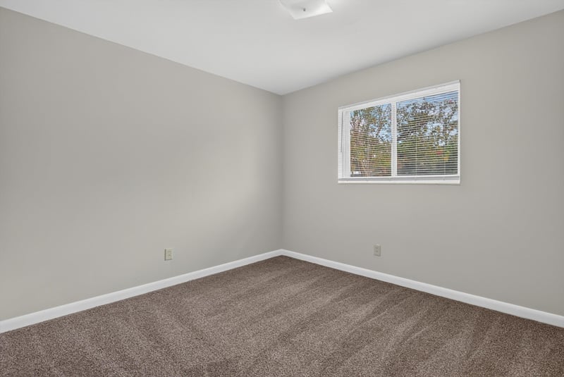 Carpeted bedroom with windows at 2618 Arlex Dr E, Jacksonville, FL