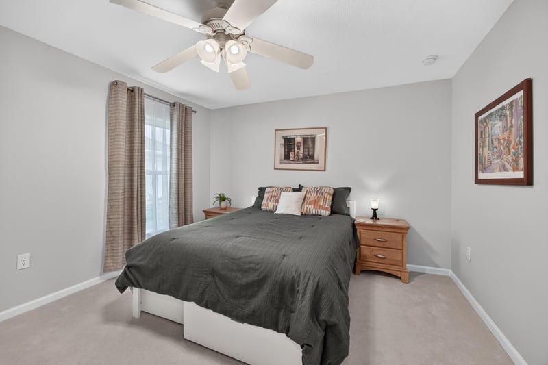 Secondary bedroom with dark green bedspread at 11225 Water Spring Cir, Jacksonville, FL 32256