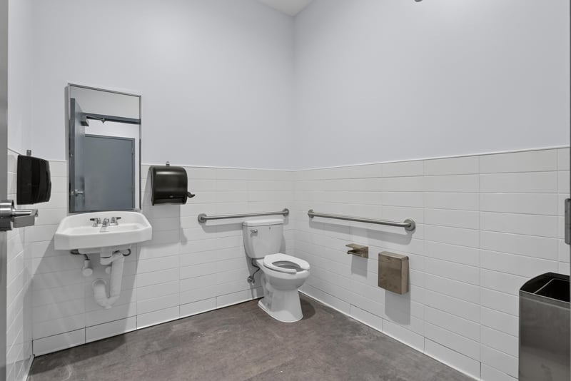 ADA-accessible restroom with grab bars and sink at 7240 Golden Wings Rd building 100, Jacksonville, FL 32244