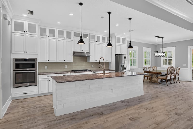 Kitchen with white cabinets and large center island at 186 Freshwater Dr