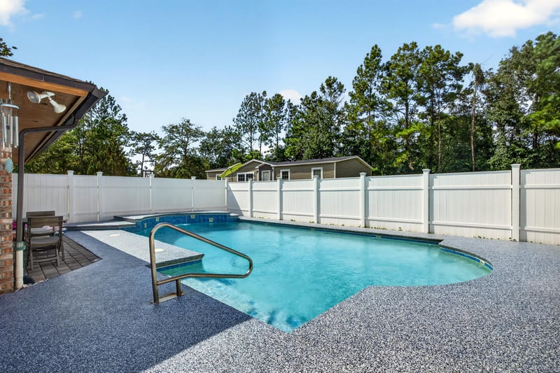 In-ground pool within screened enclosure at 2435 Range Line Rd, Middleburg, FL