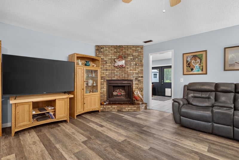 Panoramic view of living room fireplace and seating at 3249 Maryland Ave, Green Cove Springs, FL