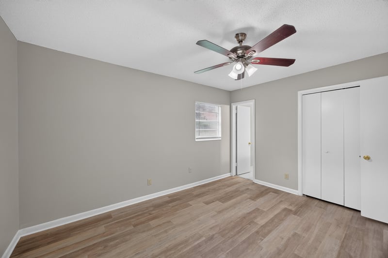 Bedroom with ceiling fan and two windows at 12351 Condor Dr