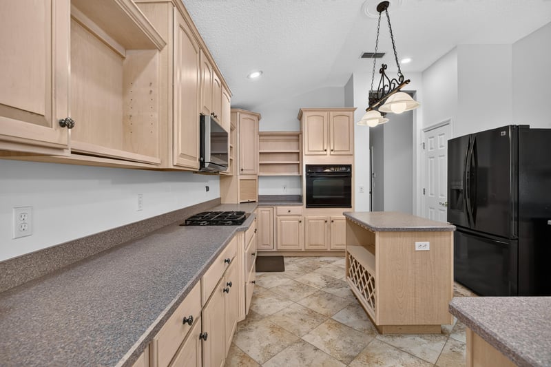 Kitchen counter and sink with wood cabinets at 11675 Magnolia Estates Rd, Jacksonville, FL 32223
