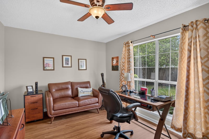 Home office with leather sofa and large window at 13514 Las Brisas Way N, Jacksonville, FL