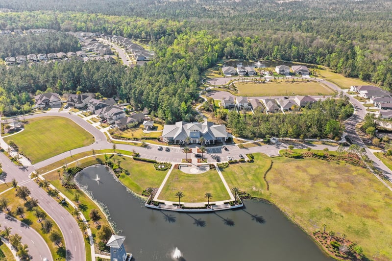 Aerial view of community streets and pond in St. Johns, FL