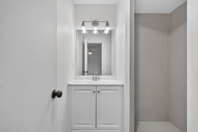 Bathroom vanity with mirror at 8177 Virgo St, Jacksonville, FL 32216