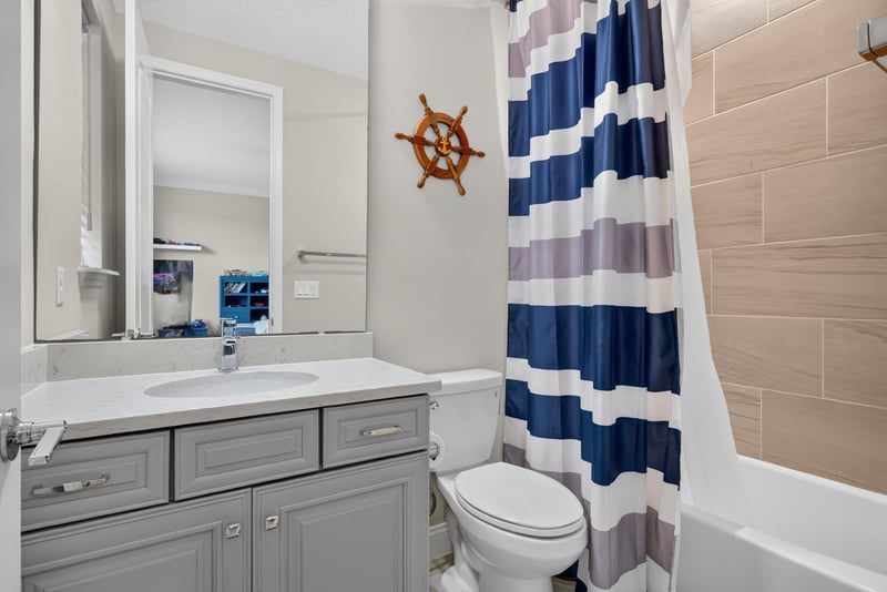 Bathroom with nautical decor and shower curtain at 22 Azura Point