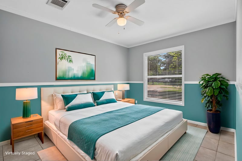 Bedroom staged with bed and teal walls at 2549 Snapdragon Ave, Middleburg, FL 32068