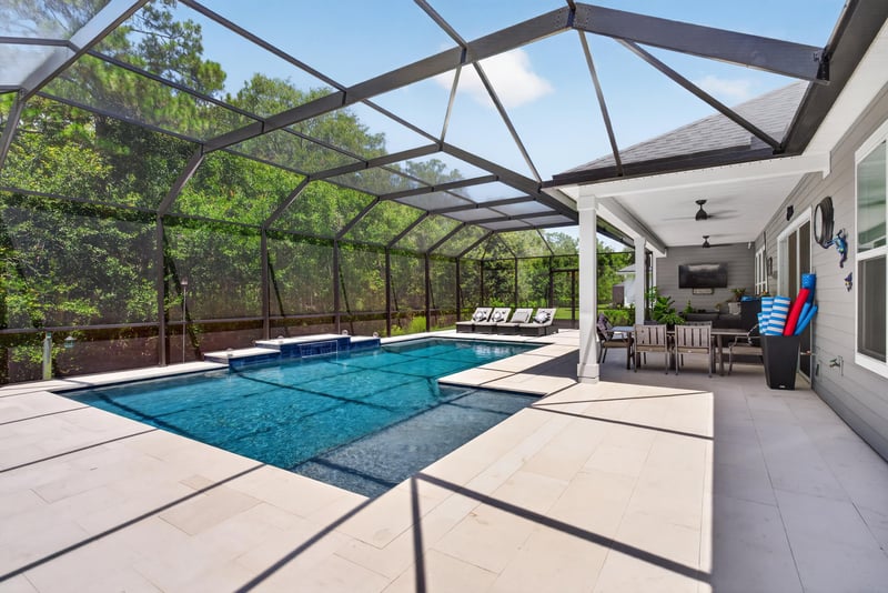 Covered lanai with pool and paver patio at 785 Back Creek Dr, St. Augustine, FL 32092