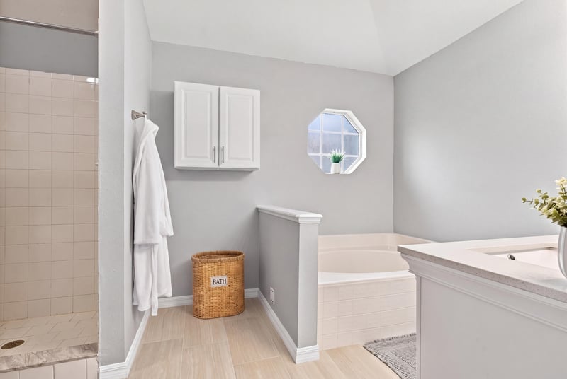 Primary bathroom soaking tub with window at 11197 Illford Dr