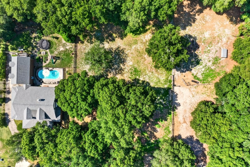 Aerial view of the home with pool among trees at 1735 Hagans Ridge Ct