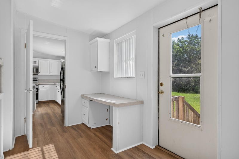Kitchen area with rear door and counter space at 3215 Robin Ln, Middleburg, FL