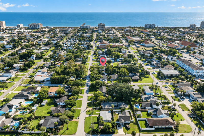 Aerial view of tree-lined street leading toward the ocean in Jacksonville Beach, FL