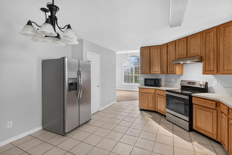 Kitchen with stainless refrigerator and tile floor at 11669 Collins Creek Dr, Jacksonville, FL 32258