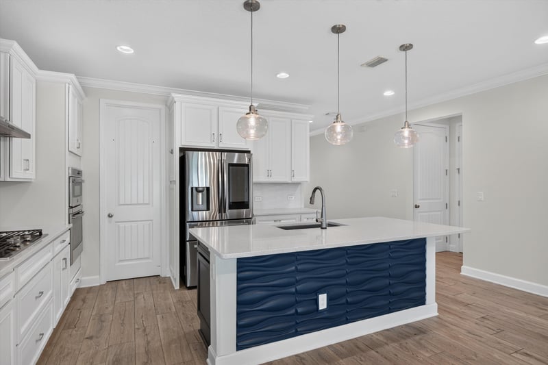 Kitchen with pendant lights and white cabinets at 855 Flach Dr, St. Johns, FL