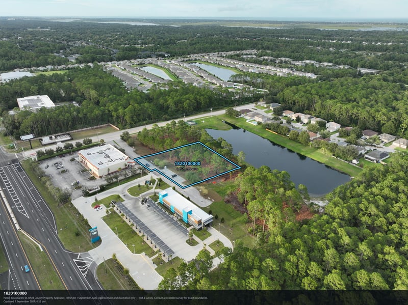 Aerial view of the commercial building, pond, and highway at 4900 US-1, St. Augustine, FL 32086