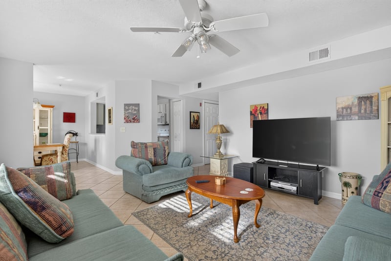 Living room seating with television and wall cabinet at 206 16th St, St. Augustine, FL 32080