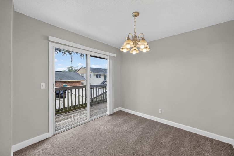 Dining area with sliding door and pendant light at 1800 Park Ave apt 358, Orange Park, FL