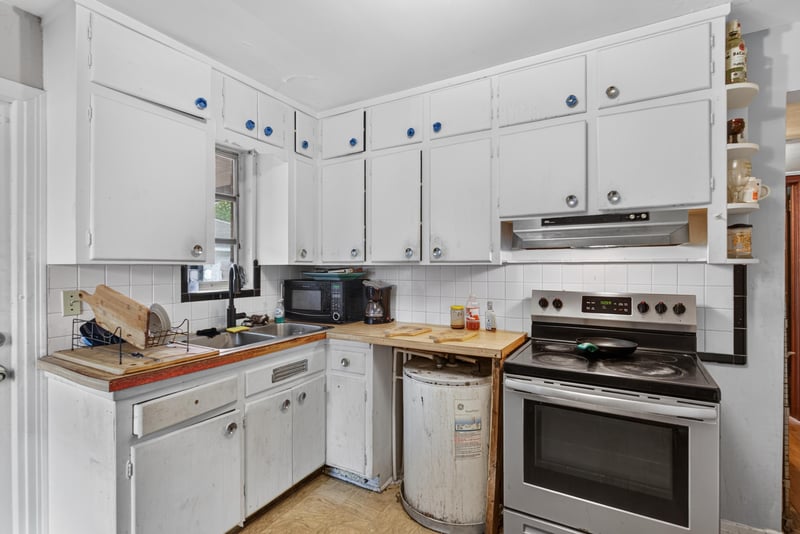 Kitchen with white cabinets and electric range at 450 E 46th St, Jacksonville, FL 32208