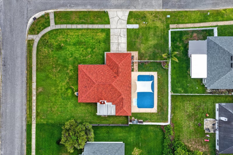 Aerial view directly above the home showing red tile roof and pool at 2164 Orangewood St, Middleburg, FL 32068