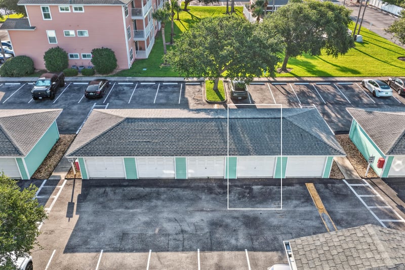 Aerial view of parking lot and nearby pink building rooftops in St. Augustine, FL