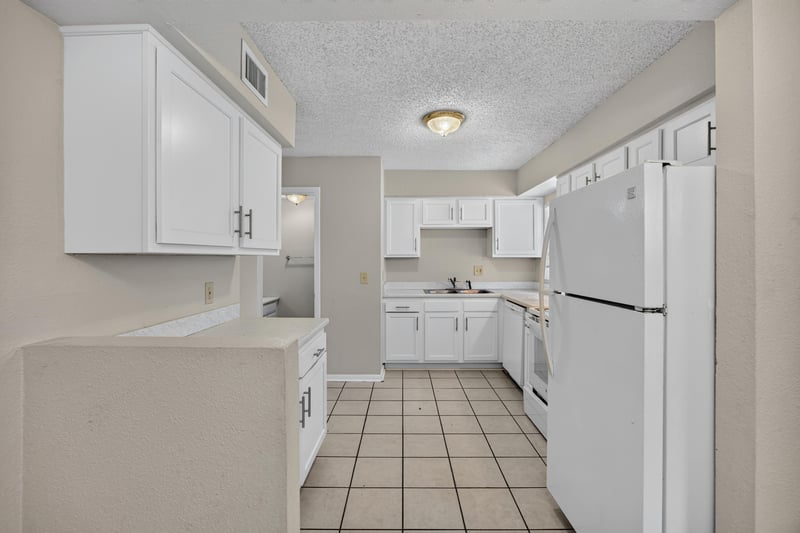 Kitchen with white cabinets and white refrigerator at 2658 Trollie Ln apt 1, Jacksonville, FL 32211