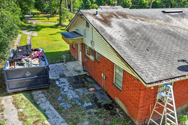 Side exterior with ladder and storage bins at 5745 110th St, Jacksonville, FL 32244