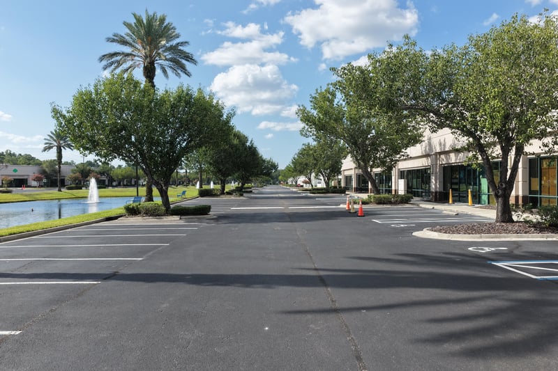 Palm-lined street with pond and fountain at 10550 Deerwood Park Blvd, Jacksonville, FL 32256