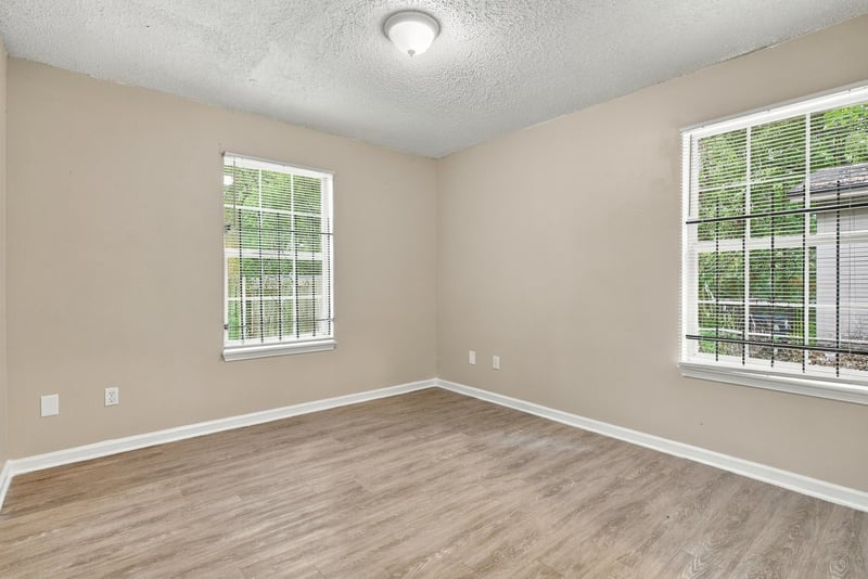 Empty bedroom with two windows and wood flooring at 219 Shortreed St, Jacksonville, FL 32254