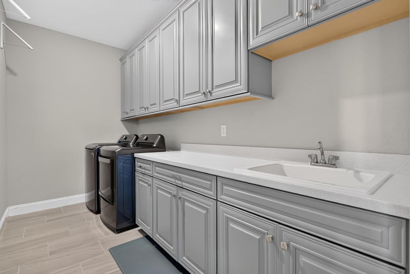 Laundry room with cabinets and sink at 22 Azura Point