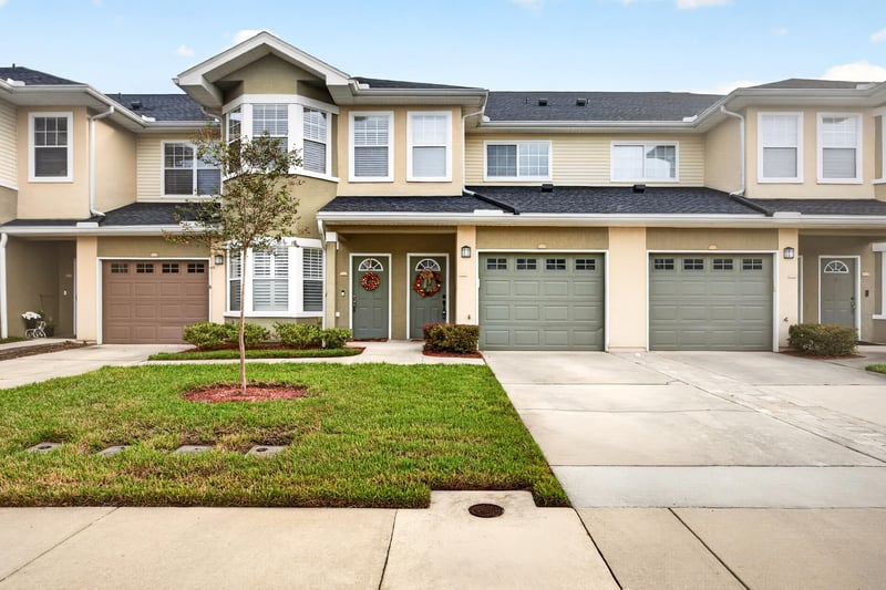 Front exterior with two-car garage and lawn at 3750 Silver Bluff Blvd, Orange Park, FL