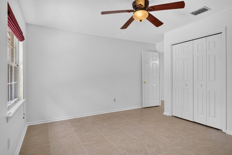 Bedroom with ceiling fan and carpet at 12810 Swamp Owl Ln