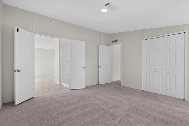 Bedroom with closet doors, unfurnished at 7603 Coach Park Dr, Jacksonville, FL 32244