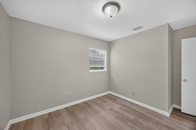 Bedroom with window and wood-look flooring at 12351 Condor Dr