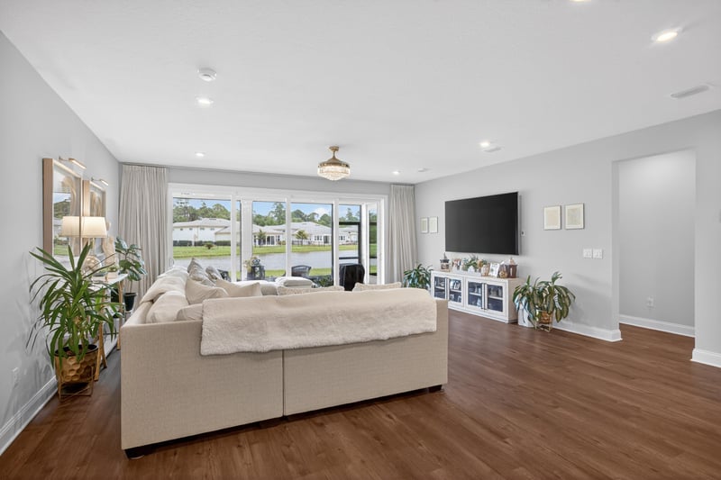Living room with wall mounted TV and wood flooring at 85491 Fall River Pkwy, Fernandina Beach, FL 32034