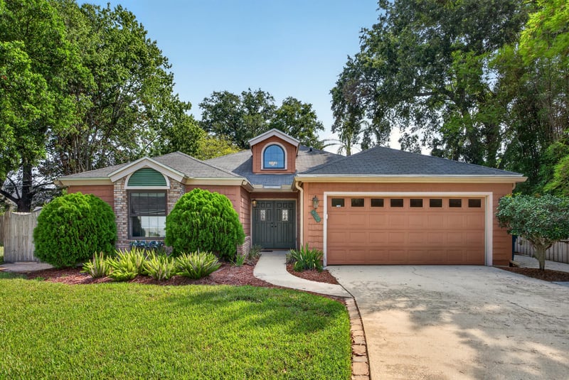 Front exterior with brick facade and driveway at 4837 Pareja Ct, Jacksonville, FL 32225