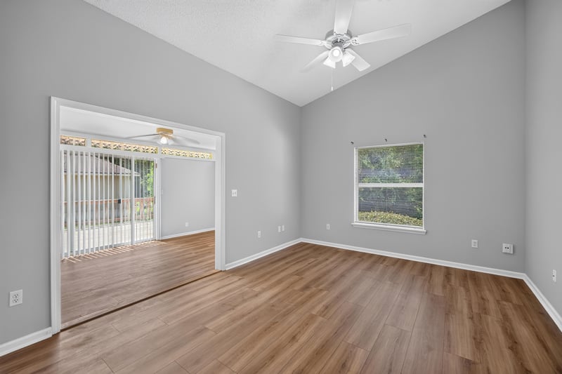 Living room with wood floor and sliding glass doors at 9256 Dale View Ln W, Jacksonville, FL 32225