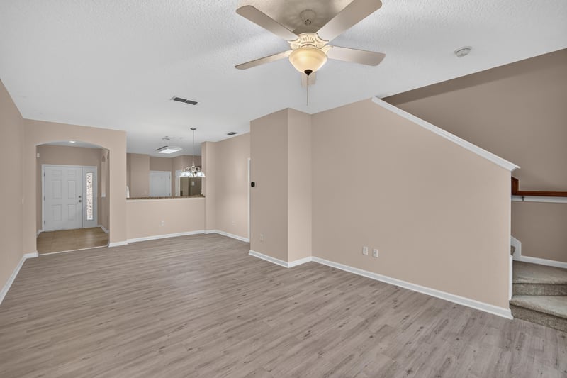 Living room with staircase visible at 3762 Hartsfield Forest Cir, Jacksonville, FL 32277
