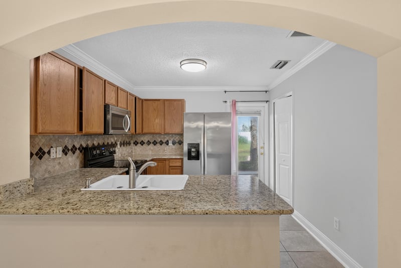 Kitchen with granite counters and pass-through bar at 353 Redwood Ln