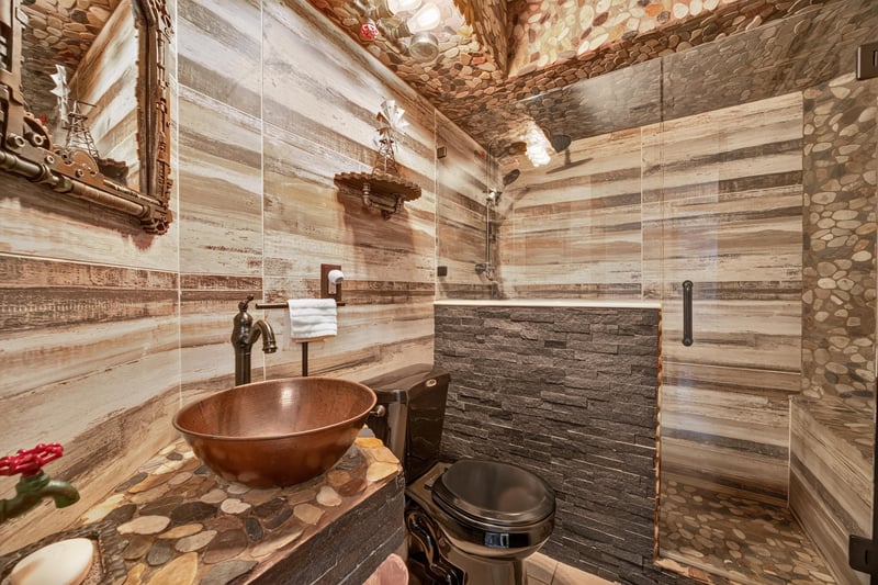 Bathroom with copper sink and stone wall at 6931 Cane Grass Ln E, Jacksonville, FL 32244