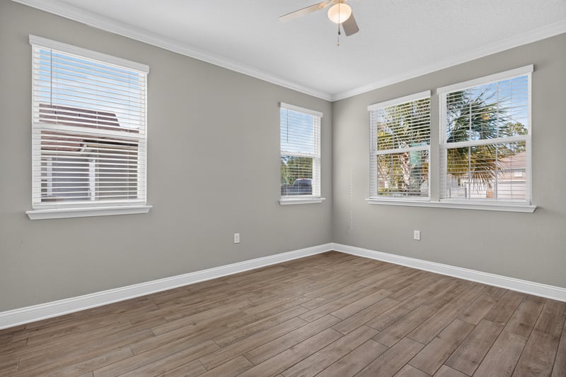 Empty flex room with wood floor and two windows at 2580 Cold Stream Ln, Green Cove Springs, FL 32043