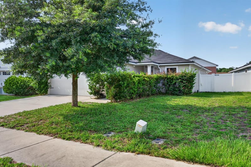 Front exterior wider daytime view with lawn and tree at 7253 Townsend Village Ct, Jacksonville, FL