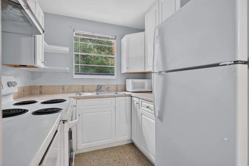 Kitchen with refrigerator and white cabinets at 5745 110th St, Jacksonville, FL 32244