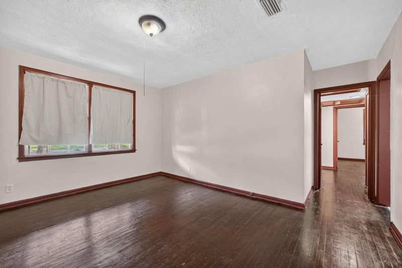 Empty living area with hardwood floors and natural light at 2132 Allandale Cir W, Jacksonville, FL